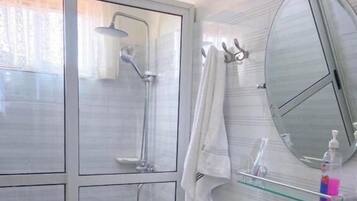 Shower, hair dryer, slippers, towels