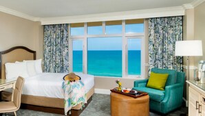 A hotel room with a bed, desk, chair, and a view of the ocean. - Seafront Double | The Shores | Oceanfront views, firepits | 2 Units (Daytona Beach)