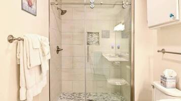 Shower, hair dryer, towels, shampoo
