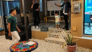 A hotel lobby with a tiled floor, a colorful round table, and a potted plant. - Nomadas hostels (Santa Marta)