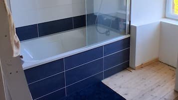 Shower, hair dryer, soap, toilet paper