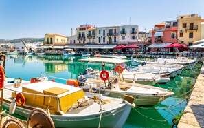 A marina with boats docked, a waterfront promenade, and buildings with balconies. - Stylish Villa w/ Heated Pool & BBQ, near Rethymno (Rethymnon)