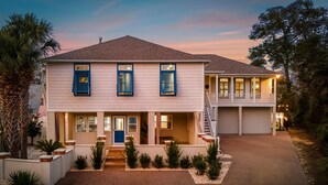 A two-story house with a front porch, a garage, and a driveway. - Walk 2 Beach |Theater, Games, Putt, Pool, Sleep 22 (North Myrtle Beach)
