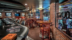 A bar area with multiple seating options, a long counter, and a brick wall with neon signage. - 2 Modern Rooms near Magnolia’s Veranda & Vibrant Fremont Street Entertainment (Las Vegas)