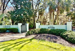 A gated entrance with a sign reading 'PRIVATE evian' and 'SHIPYARD DRIVE'.