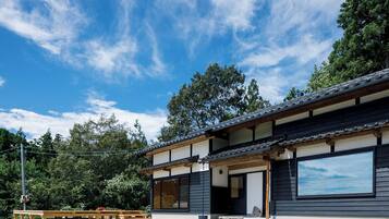 A traditional Japanese-style building with a wooden exterior and large windows.