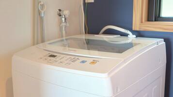 A front view of a white washing machine with a digital display and control panel.