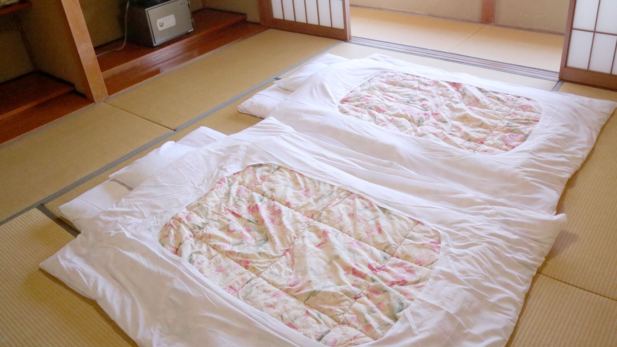 Tatami mats with a quilted blanket in a traditional Japanese room.