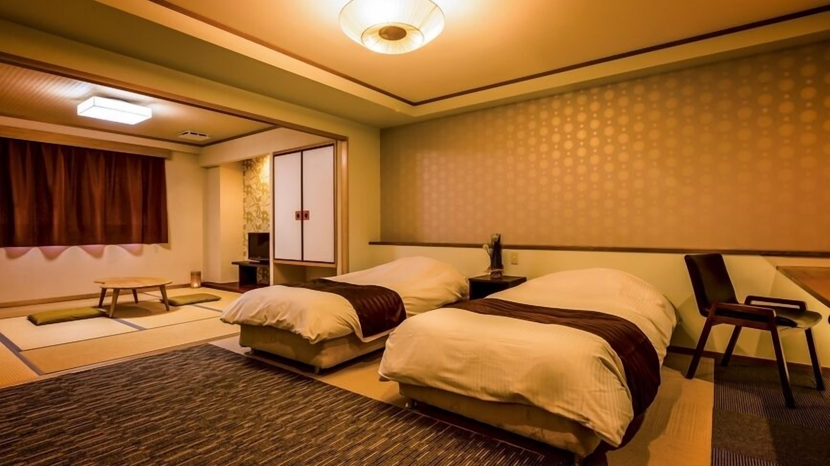 A hotel room with two beds, a sitting area, a traditional Japanese sliding door, and a patterned wall.