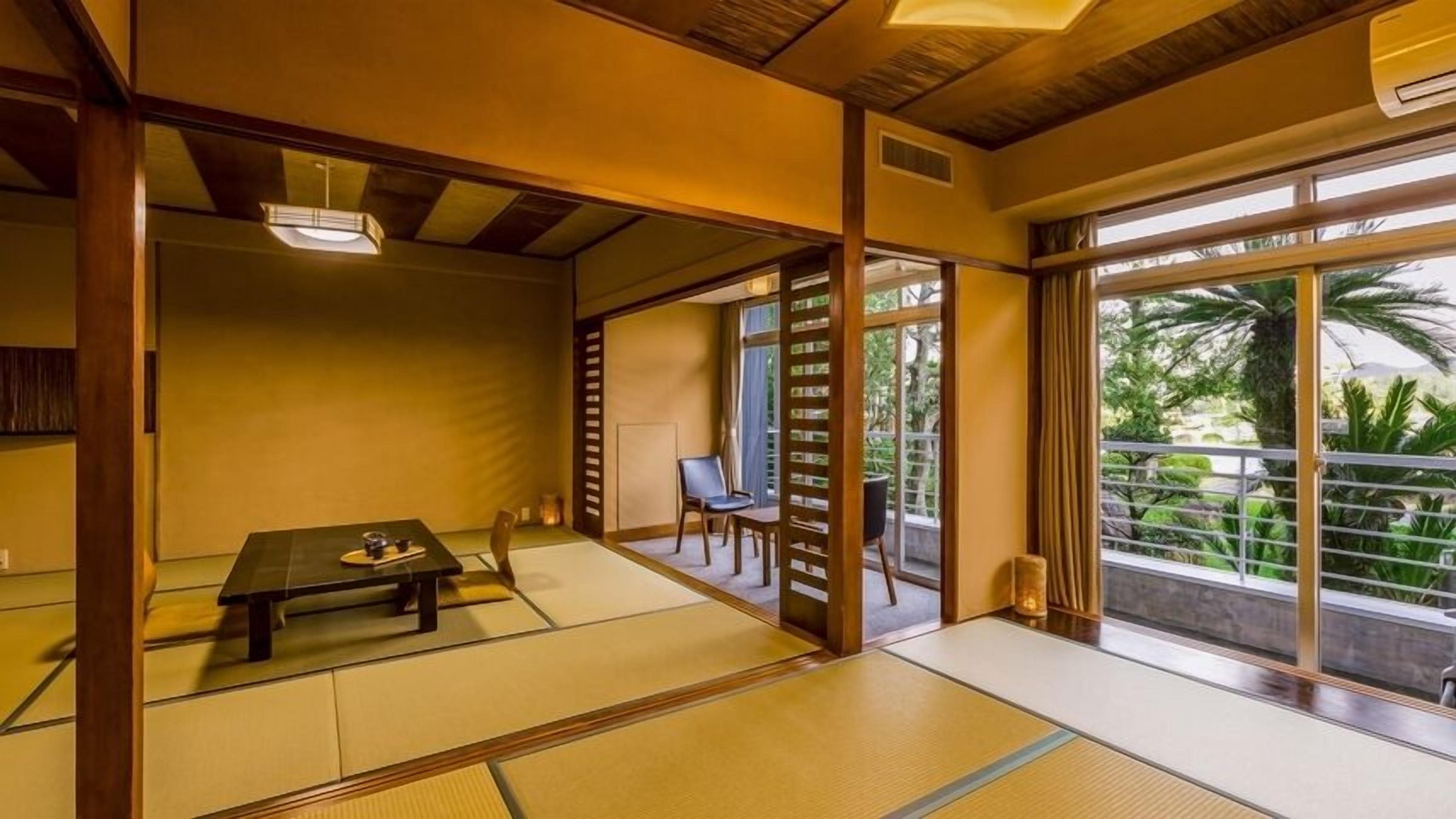 A traditional Japanese room with tatami flooring, a low table, sliding doors, and a view of greenery outside.