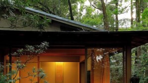 A modern, cozy interior with a seating area, a table, and a lamp. - Ureshino Onsen Taishouya (Ureshino)