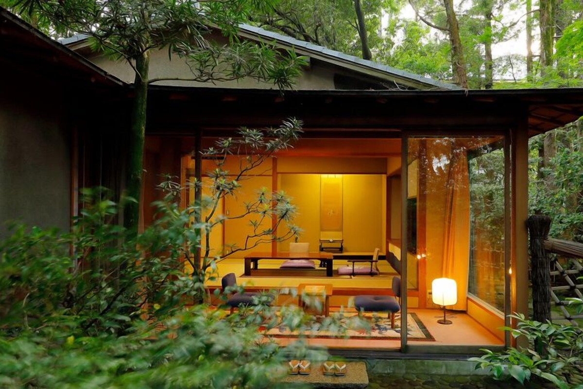 A traditional Japanese-style room with tatami flooring, a low table, and a sliding door.