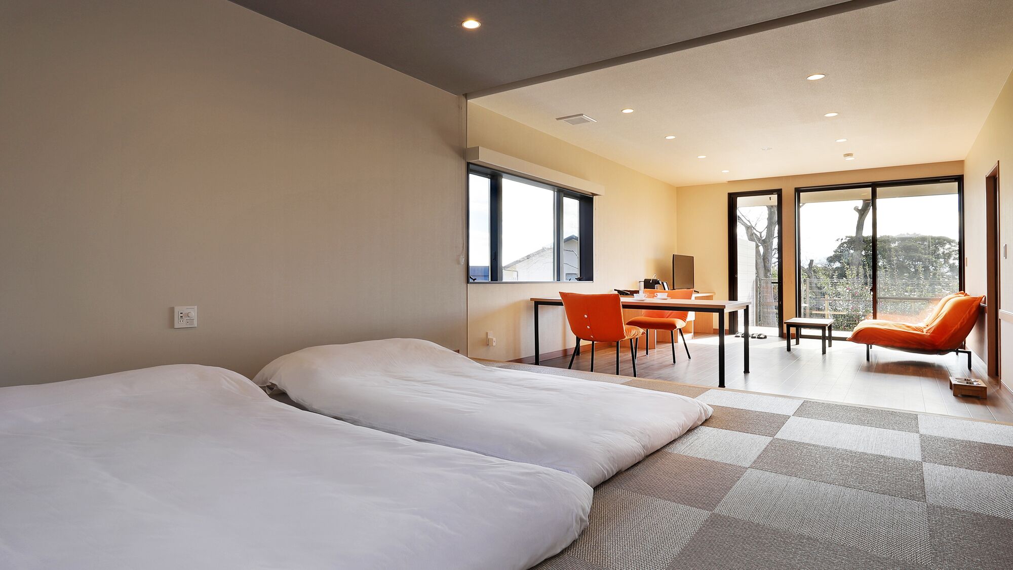 A modern hotel room with two beds, a desk, and a chair.