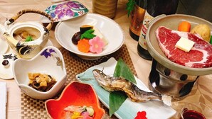 A variety of dishes including sushi, sashimi, and grilled meat, arranged on a table with various bowls and plates. - Ryokan Keizanso (Nasushiobara)