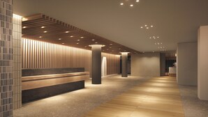 A modern interior with a wooden bench, a patterned wall, and a long corridor. - OND Hotel (Takeo)