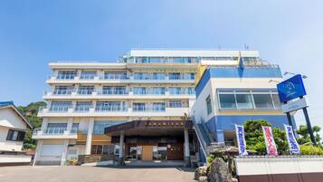 A multi-story hotel with a prominent entrance and signage.