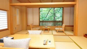 A traditional Japanese-style room with tatami flooring, low wooden tables, and sliding shoji screens. - Worifushi no Yado Shougetsu (Koriyama)