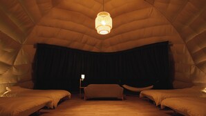 A tent-style room with two beds, a hammock, and a hanging light fixture. - Eight Village (Kujukuri)