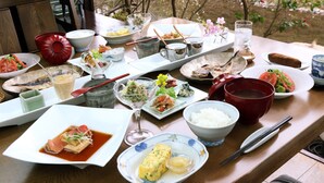 A table set with various dishes, including sushi, rice, and a bowl of soup. - Auberge Hanagoyomi (Ito)