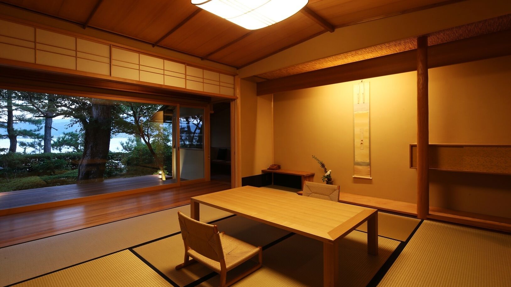 Ein traditioneller japanischer Raum mit Tatami-Boden, einem niedrigen Tisch und Schiebetüren.