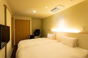 A hotel room with two beds, a wardrobe, a TV, and a coat rack. - Kamai Onsen Ippenan (Kyotango)
