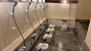 A public restroom with multiple sinks, urinals, and toilet paper dispensers. - Pica Fuji Saiko (Fujikawaguchiko)