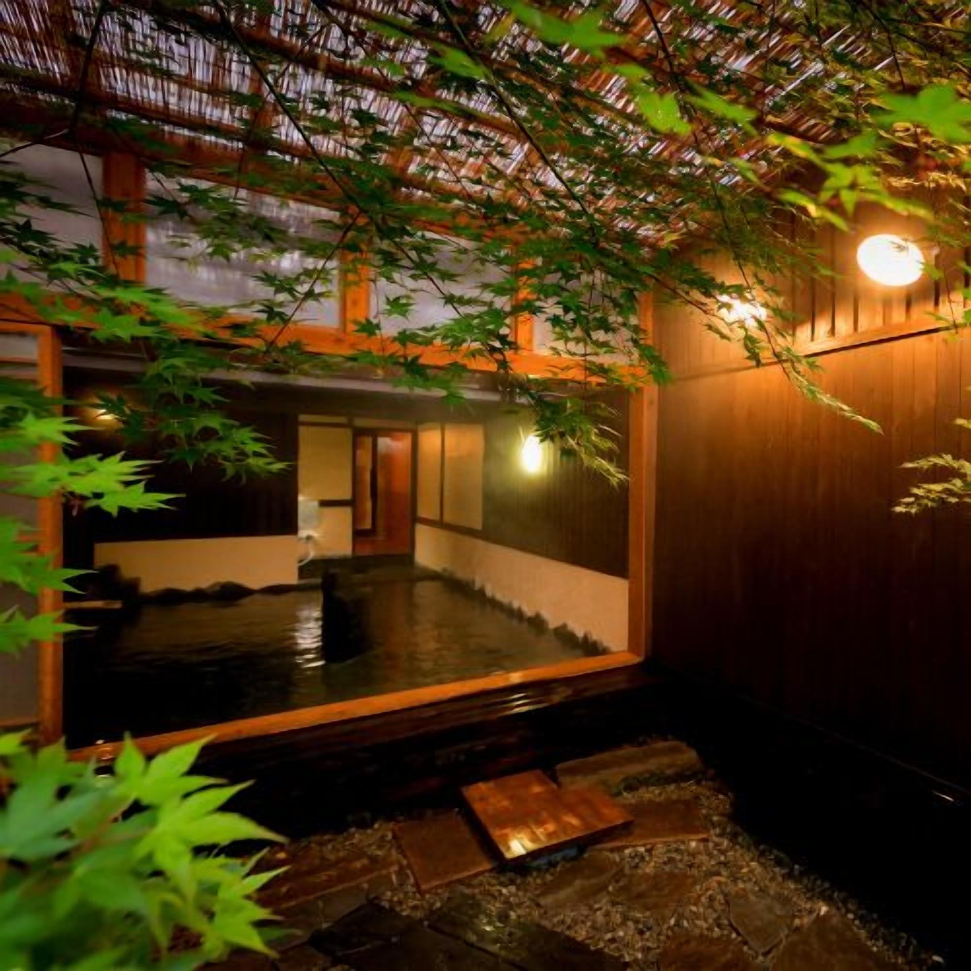 A traditional Japanese interior with tatami flooring, a wooden sliding door, and a stone lantern.