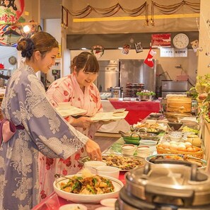 A buffet setup with various dishes and a clock on the wall. - Asouchinomaki Onsen Yumeoiso (Aso)