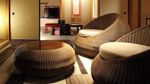 Une pièce de style japonais traditionnel, avec un sol recouvert de tatamis, un plafond bas en bois et des portes coulissantes.