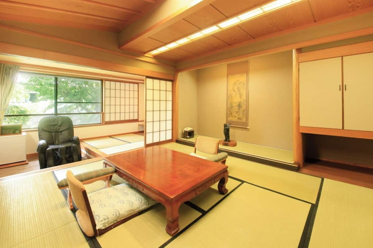 A traditional Japanese room with tatami flooring, a low wooden table, and a shoji screen.