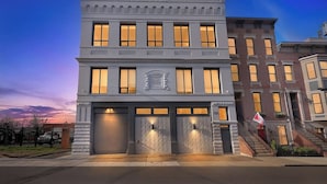 A two-story building with a central entrance, large windows, and a garage door.