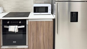 A modern kitchen with a built-in oven, microwave, and stainless steel refrigerator. - Luxury 2BR Apartment · 1 min to Beach (Larnaka)