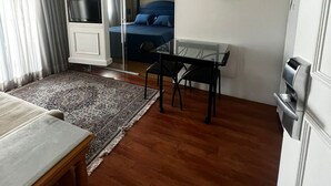 A room with a bed, a TV, a desk, and a chair. - Flat em Moema com Cozinha (São Paulo)