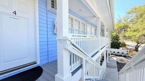 A white building with a blue door marked 'No Smoking' and the number '4'. - Sun-Joy Getaway #5 | Near Boardwalk, Walk to Beach (Myrtle Beach)
