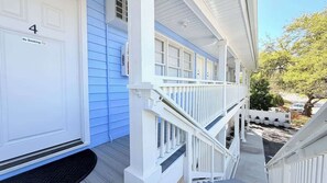 A white building with a blue door marked 'No Smoking' and the number '4'. - Sun-Joy Getaway #5 | Near Boardwalk, Walk to Beach (Myrtle Beach)