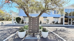 A building with a blue roof, a large tree in front, and a utility box with multiple compartments. - Sun-Joy Beach Stay#6, 5-Min Walk, Central Location (Myrtle Beach)