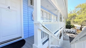 A white building with a blue door marked 'No Smoking' and the number '4'. - Sun-Joy Beach Stay#6, 5-Min Walk, Central Location (Myrtle Beach)