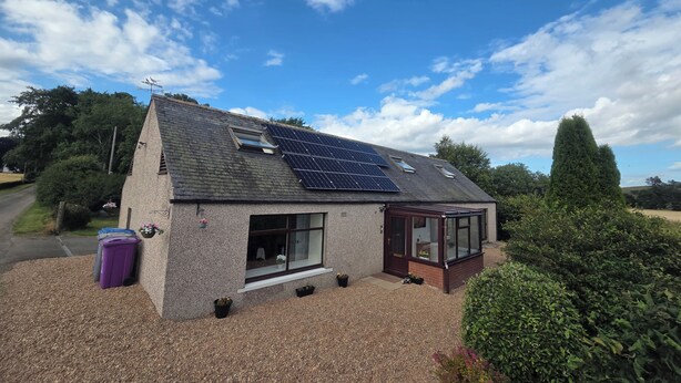 A house with solar panels, a conservatory, and a gravel driveway. - Farm Cottage at Foot Angus Glens (Kirriemuir)