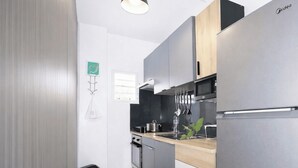 A modern kitchen with stainless steel appliances, a wooden countertop, and a black backsplash. - Cozy 2 Bedroom Flat W Pool/ Free Parking (Philipsburg)