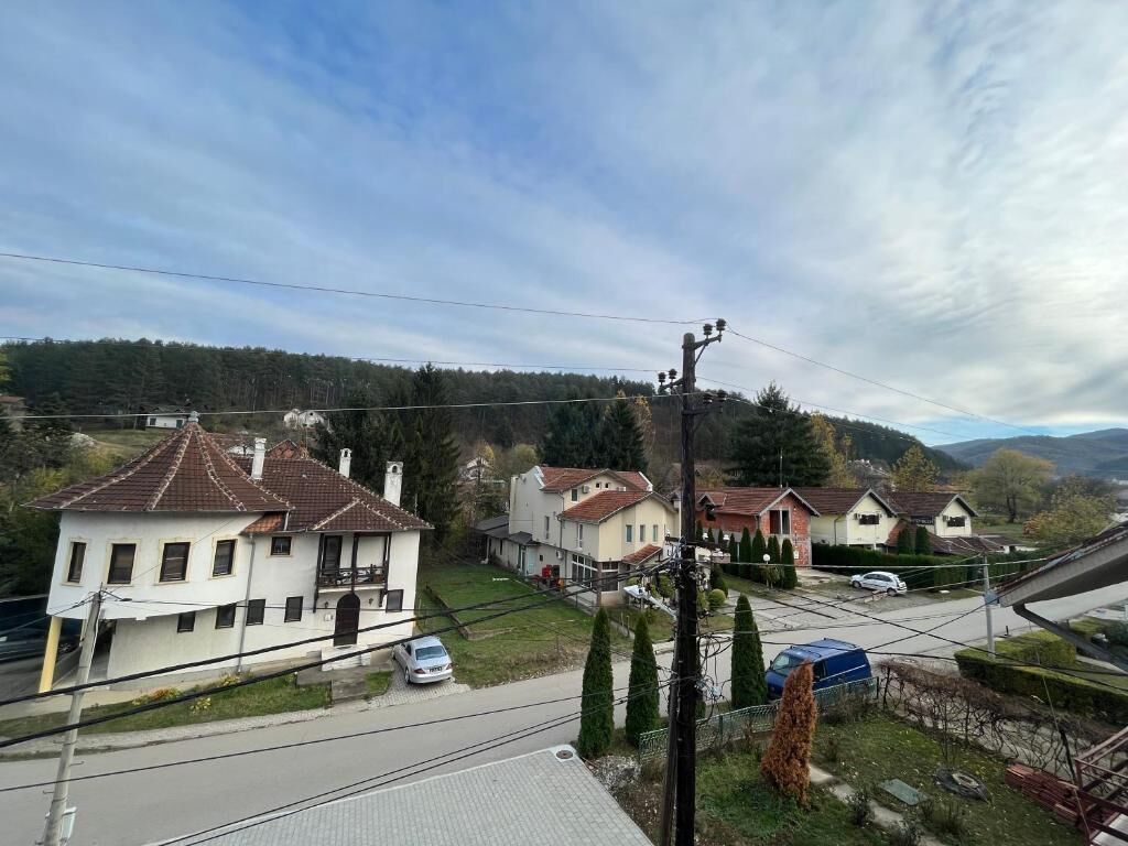 A residential area with houses, a road, and a power line.