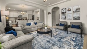 A living room with a sofa, armchairs, a coffee table, and a ceiling fan. - Quiet Boise Retreat|Hot Tub•Game Room• 4BR (Boise)
