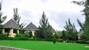 A residential area with houses featuring pitched roofs and surrounded by lush greenery.