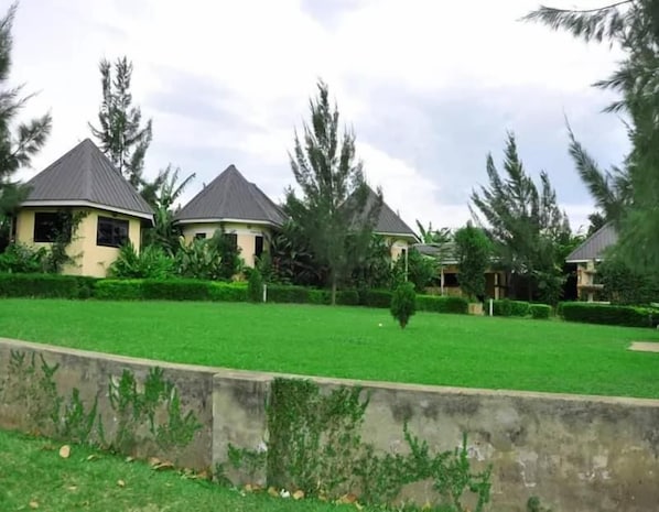 A residential area with houses featuring pitched roofs and surrounded by lush greenery.