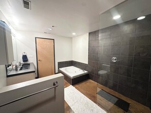 Jetted bath, hair dryer, towels, toilet paper