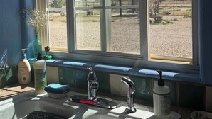 A kitchen with a window, sink, and various toiletries. - Jill's place is Cozy 2 bedroom cottage on a quiet dead end road, near Cortez. (Cortez)