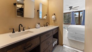 A bathroom with two sinks, a mirror, and a ceiling fan. - Lodgepole #2020 (Keystone)