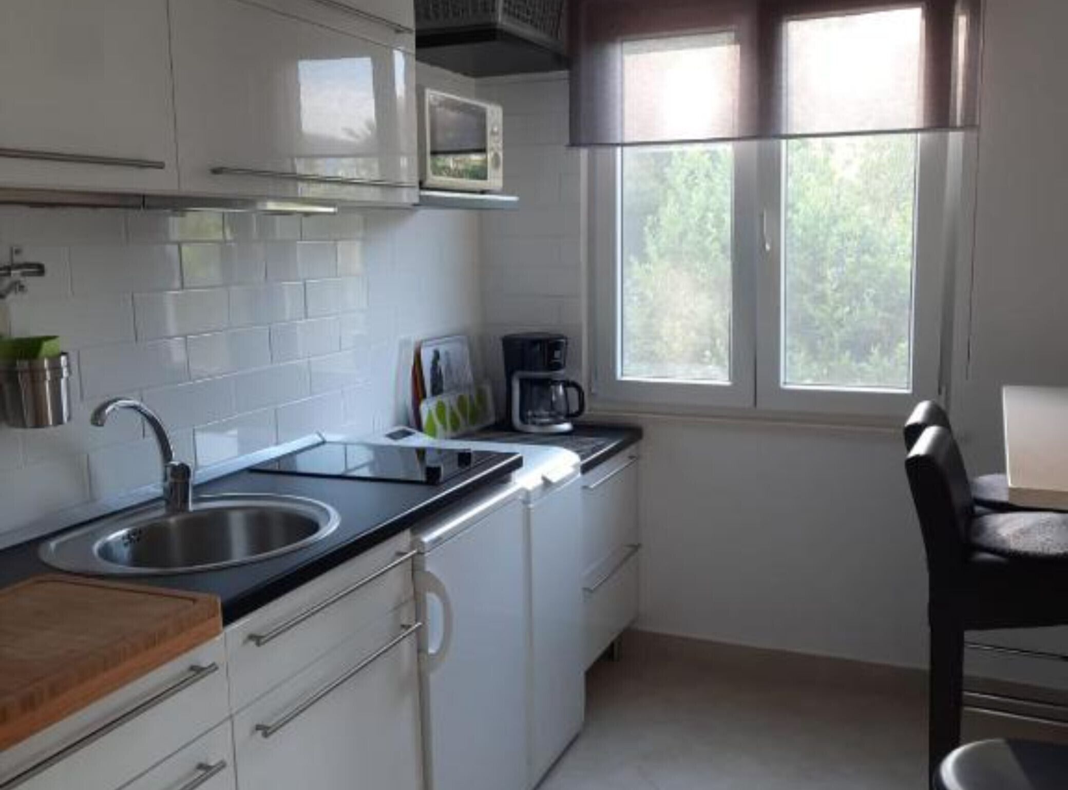 Fridge, microwave, coffee/tea maker, cookware/dishes/utensils