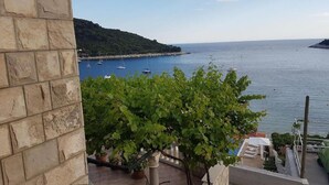 A stone building with a view of a calm sea and boats. - Villa Azure Saplunara - One bedroom apartment (Saplunara)