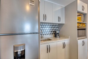 Fridge, microwave, stovetop, coffee/tea maker - Dog-friendly apartment with rooftop infinity pool, gym, central AC, & balcony (Cabo San Lucas)