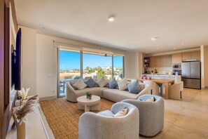 TV, offices - Bright coastal condo with ocean-view balcony, gym, pools, BBQ & kid’s park (Cabo San Lucas)